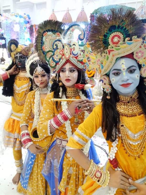 "Krishna Jhanki depicting a vibrant dance performance in front of an audience, highlighting the traditional attire, graceful movements, and spiritual ambiance of the scene."